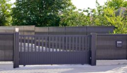 dark grey gate aluminum portal with blades suburbs house street